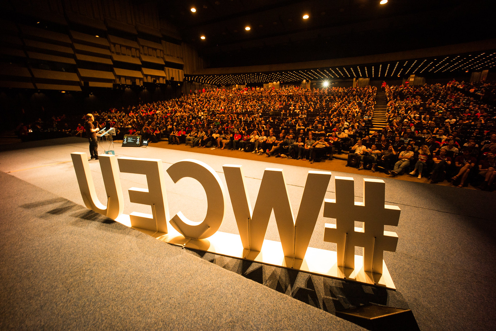 Stage view of the audience, in front the #WCEU letters seen from the back side